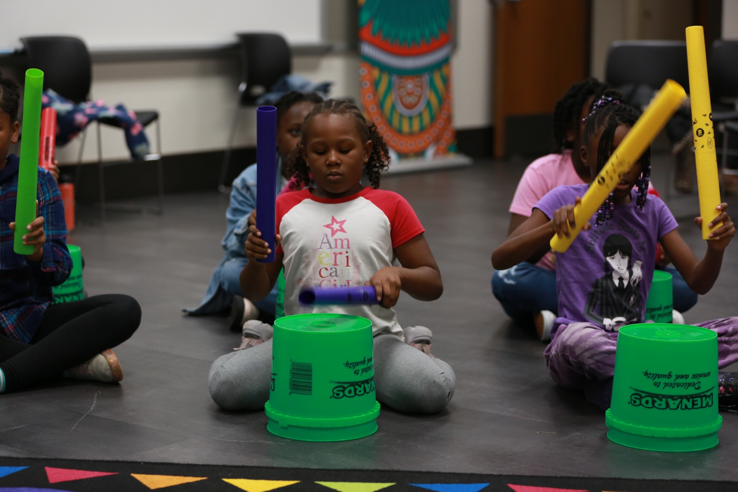 Children creating rhythm together in an Asante workshop