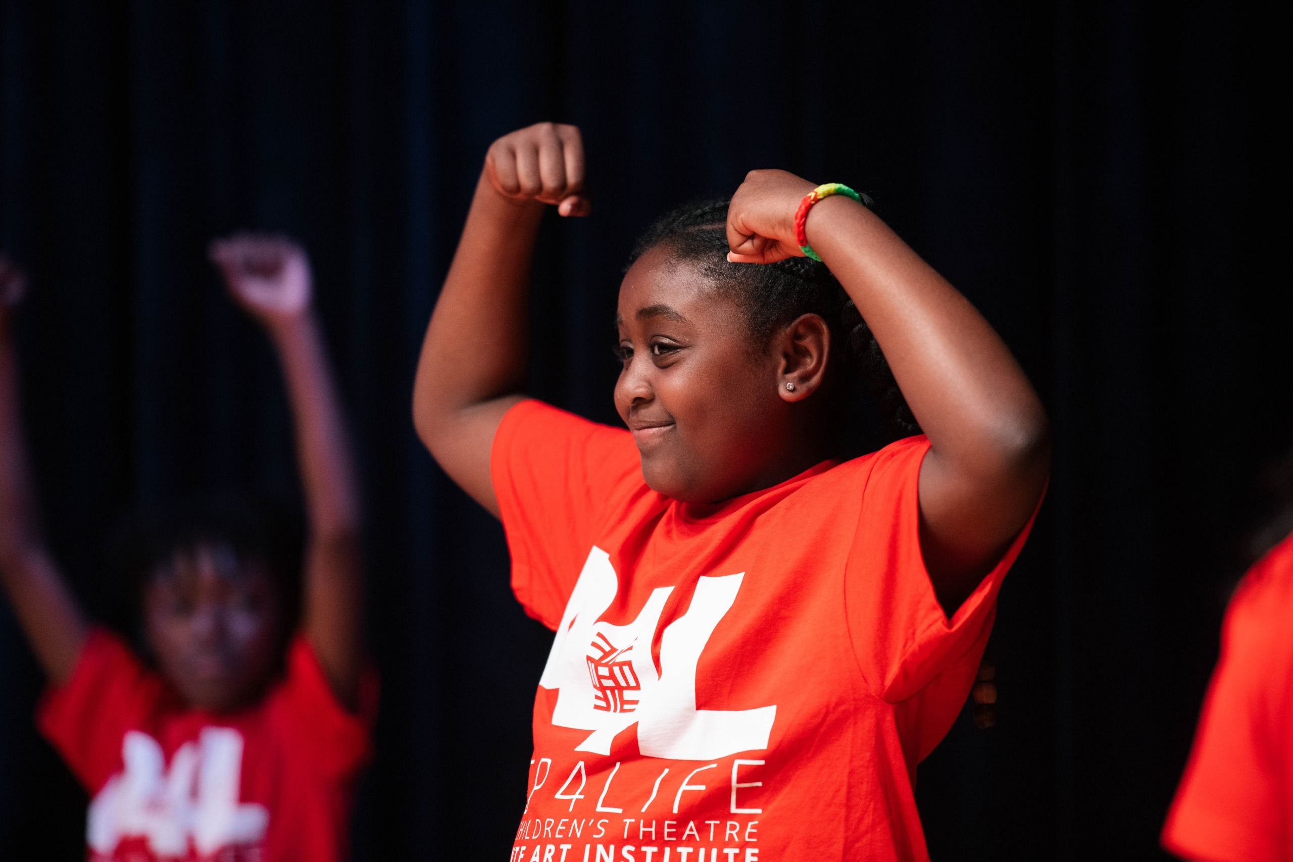 Young Asante performer expressing strength on stage